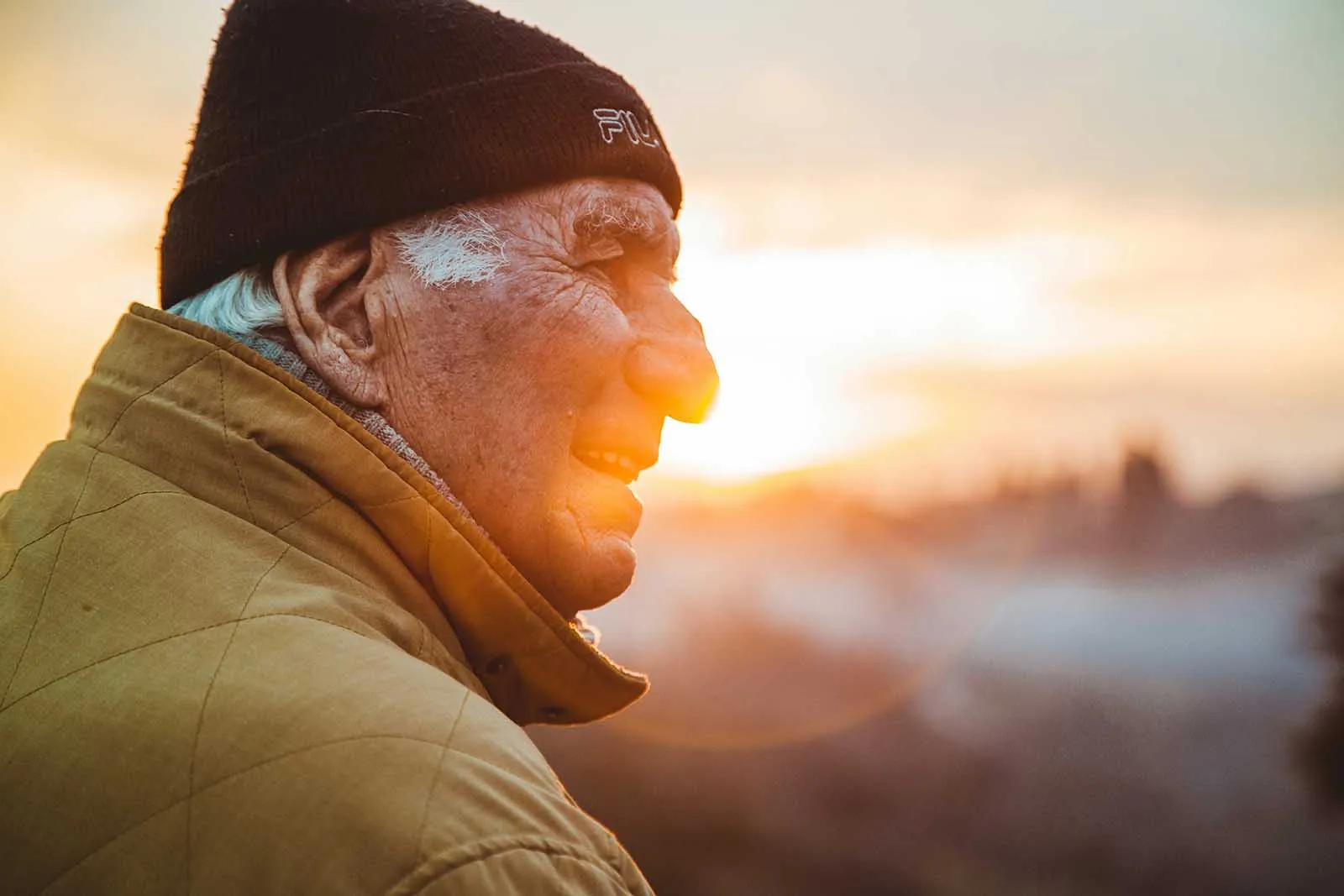 An older man wearing a beanie at sunrise, illustrating the natural decline of testosterone with age and the importance of maintaining hormone health through lifestyle interventions.