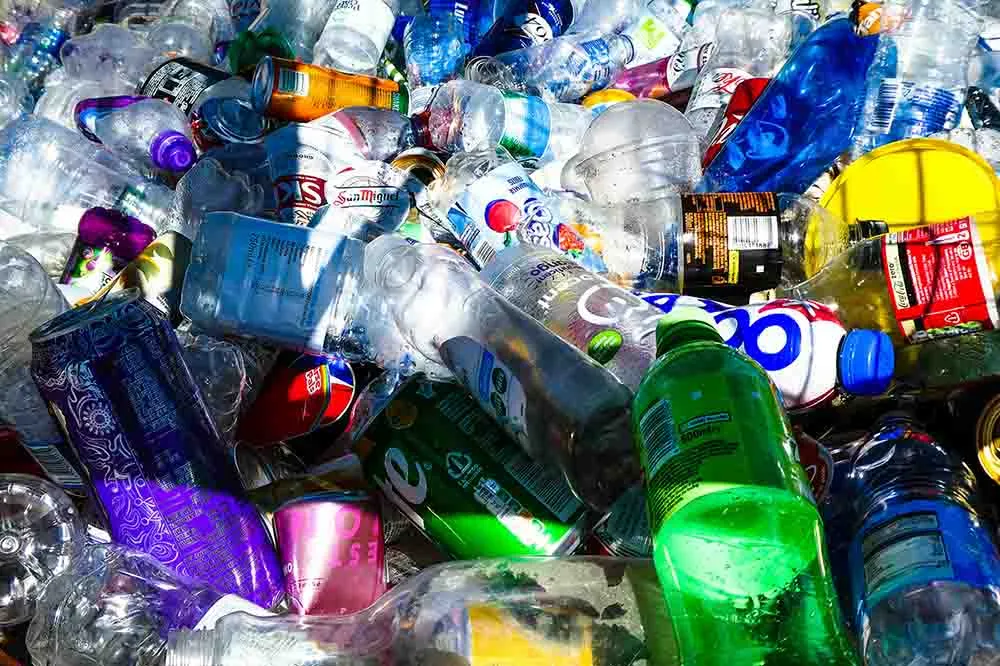 A large assortment of used plastic bottles, representing environmental endocrine disruptors like BPA that can lower testosterone levels.